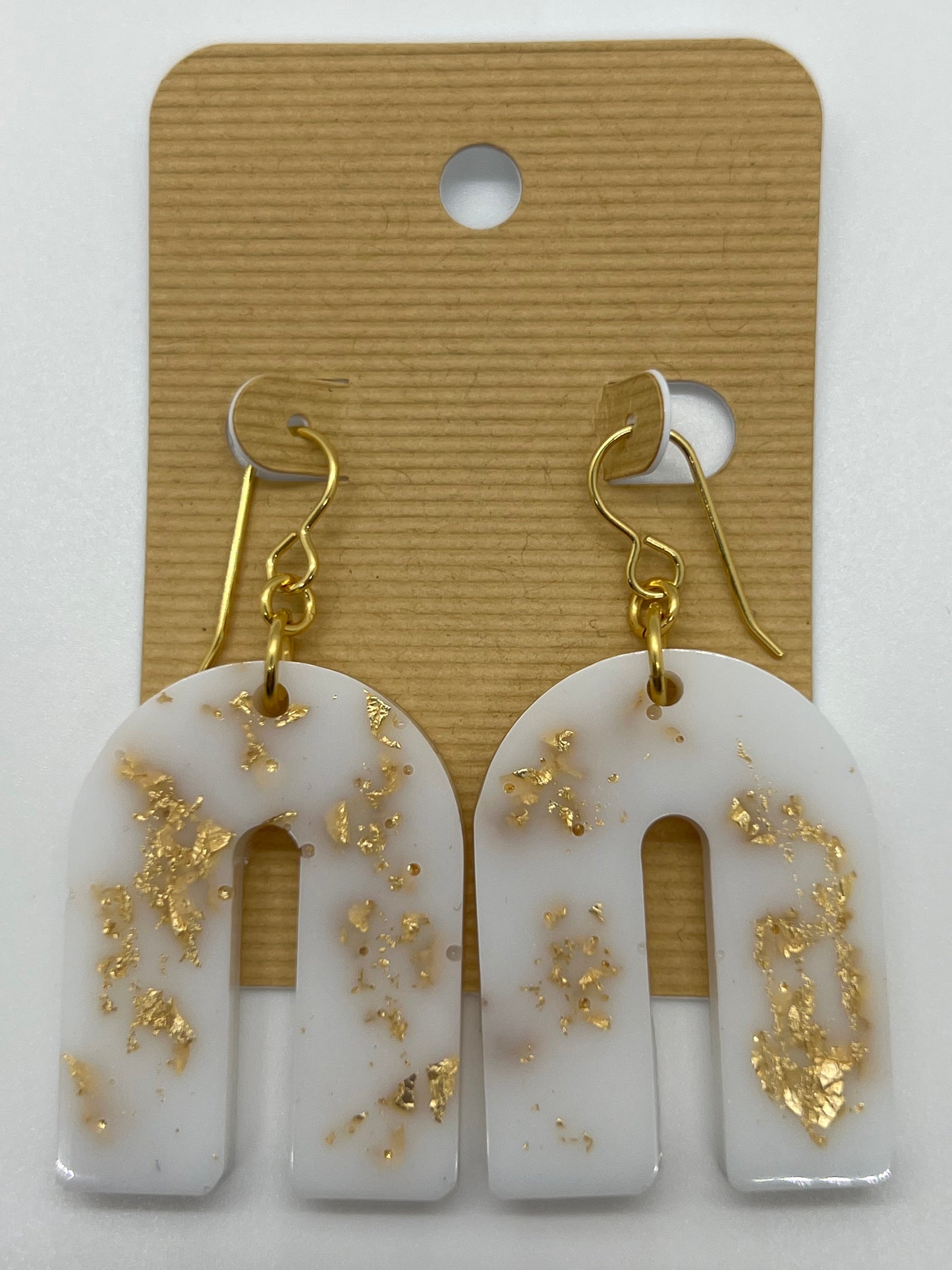 White arch earrings with gold flakes