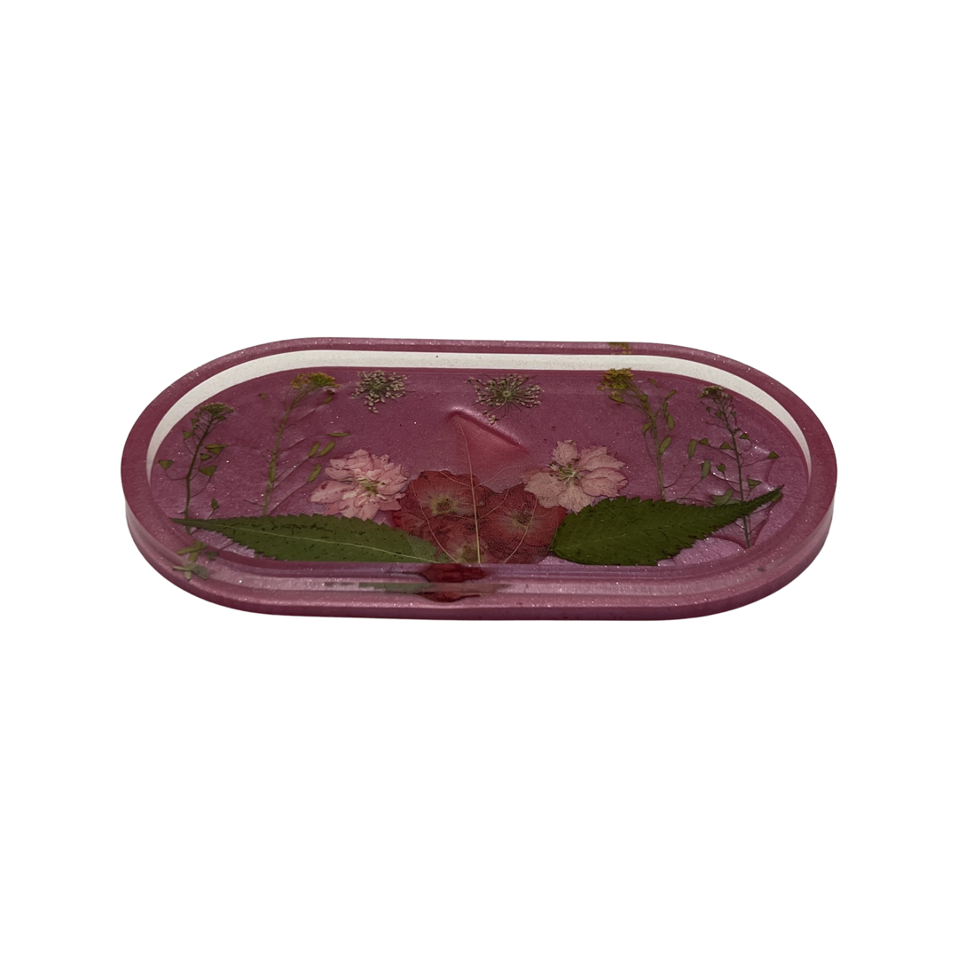 Pink oval tray filled with multicolored flowers