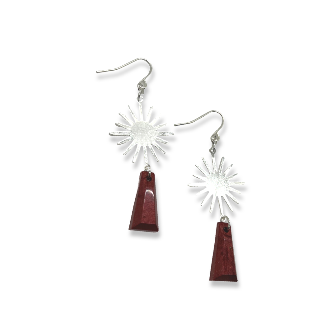 Silver sun charm with burgundy shapes