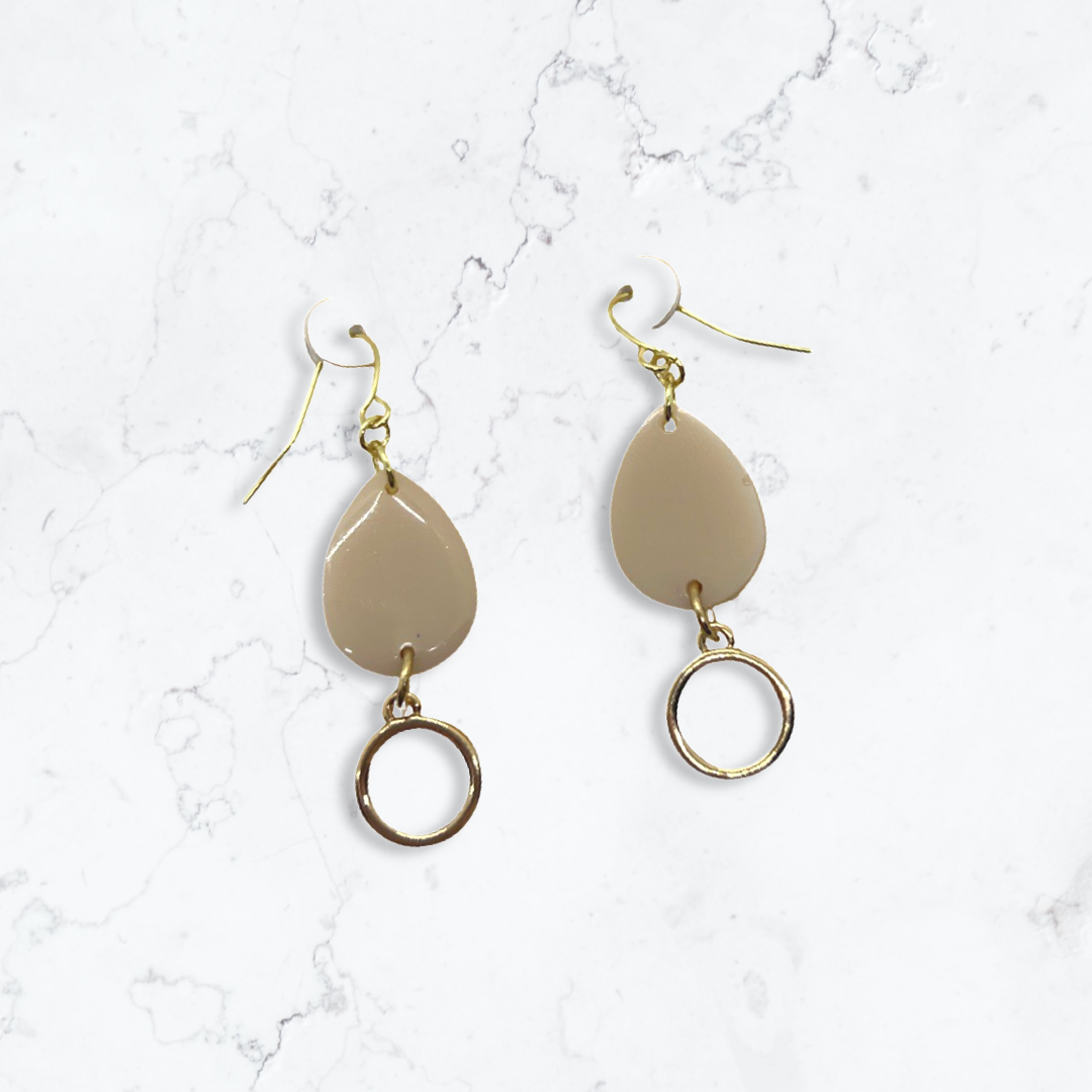 Beige tear drop with small round charm