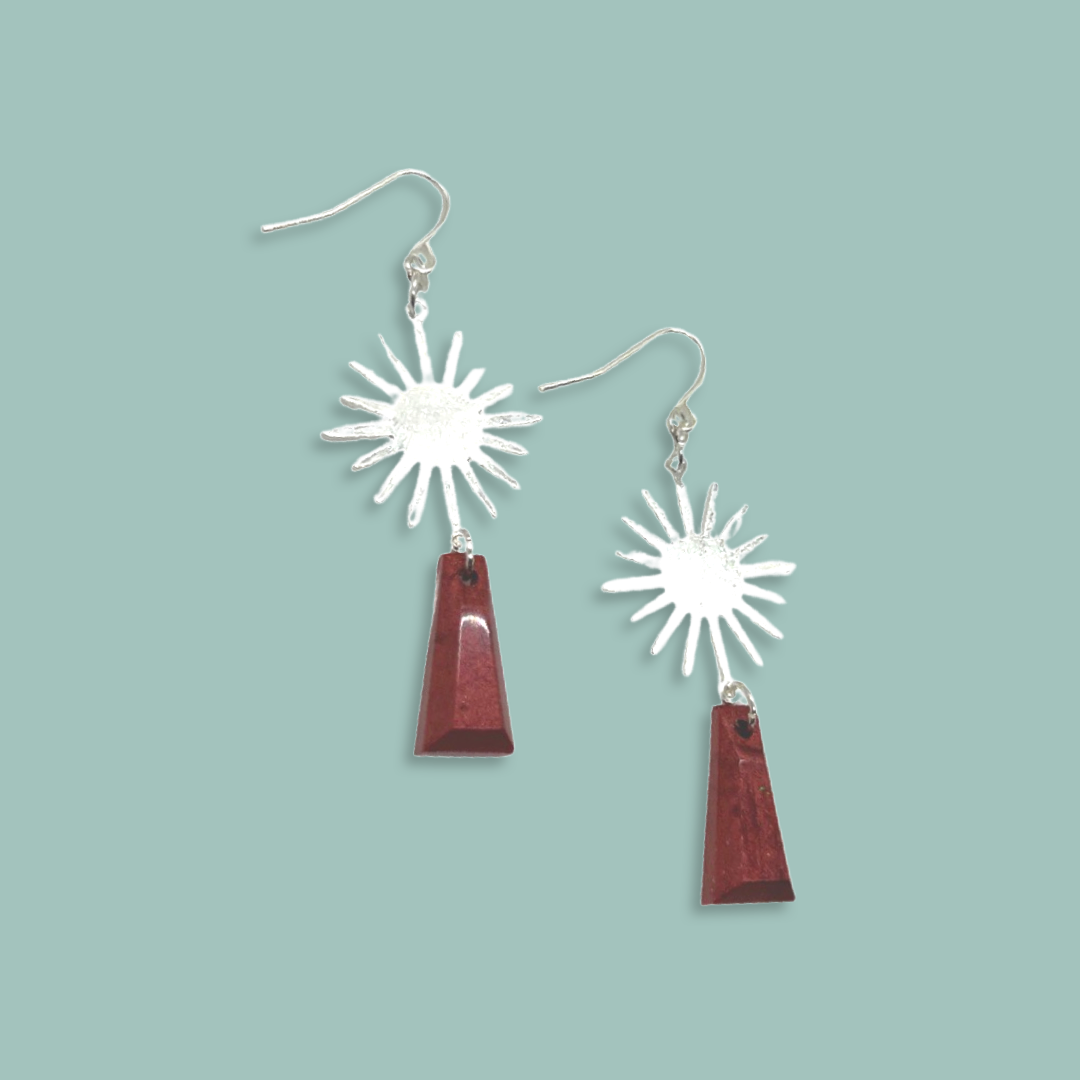 Silver sun charm with burgundy shapes