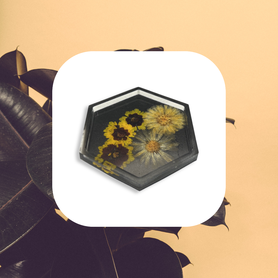 Black hexagon coaster filled with yellow flowers