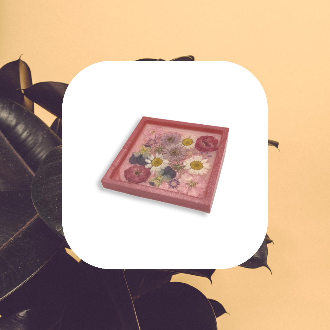 Pink square coaster filled with multicolored flowers