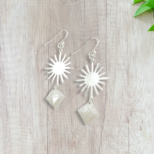 Silver sun charm with white glittery squares