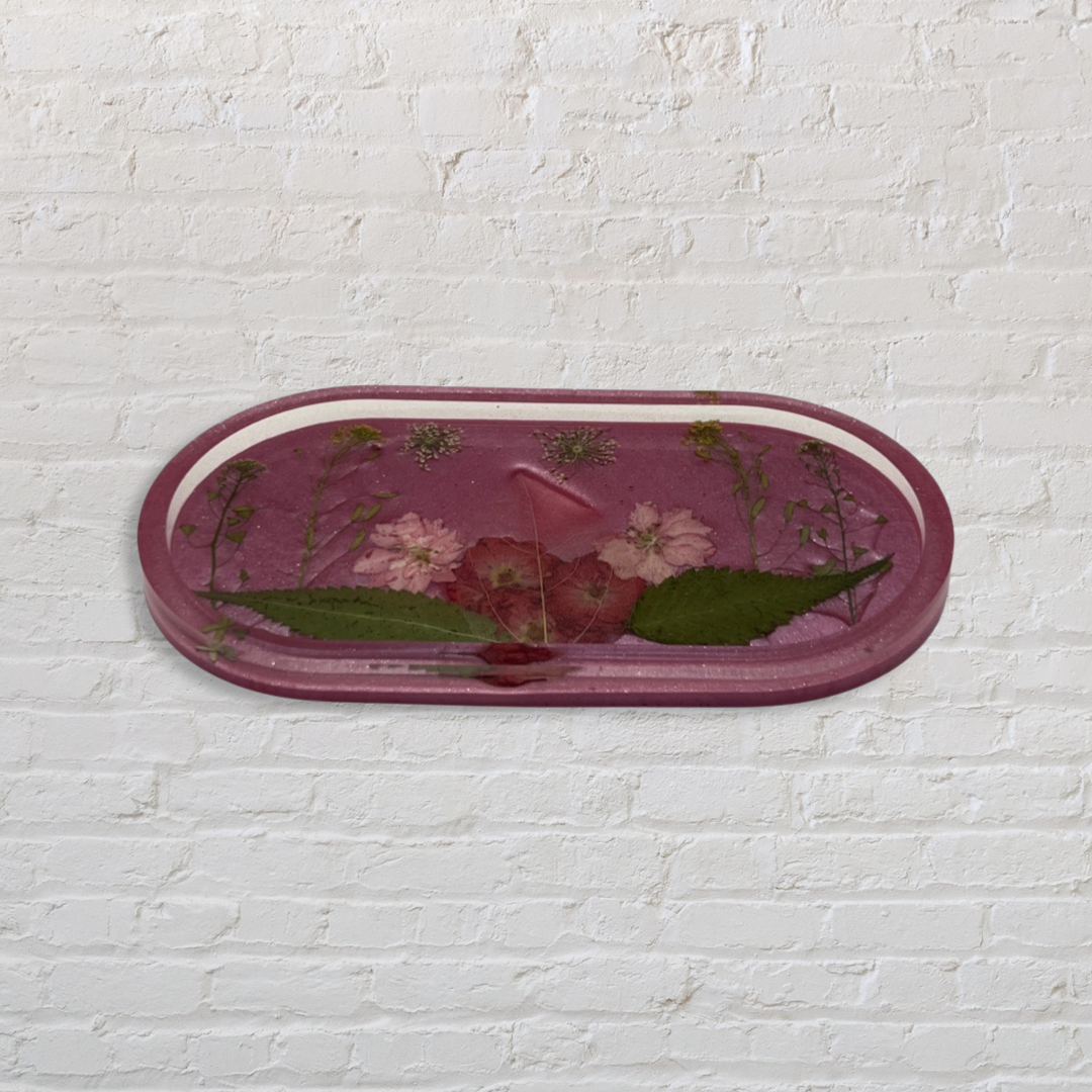 Pink oval tray filled with multicolored flowers