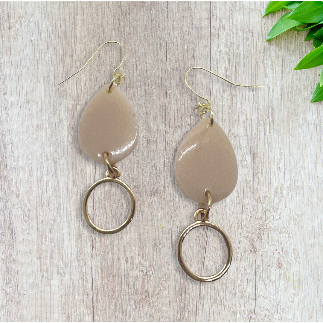 Beige tear drop with small round charm