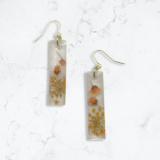 Milky rectangle dangles with orange flowers