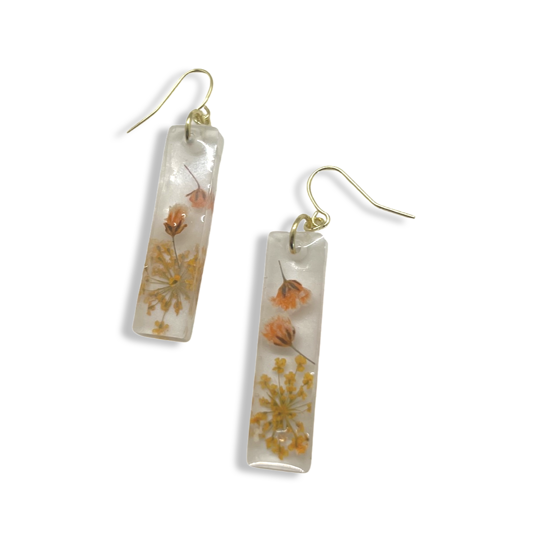 Milky rectangle dangles with orange flowers